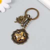 Брелок металл, стекло с карабином "Цветочек и узоры в медальоне" бронза 9,5 см Брелок металл, стекло с карабином "Цветочек и узоры в медальоне" бронза 9,5 см