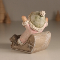 Сувенир полистоун "Малышка в санках, летит с горки" розовый 9х7,8х9 см