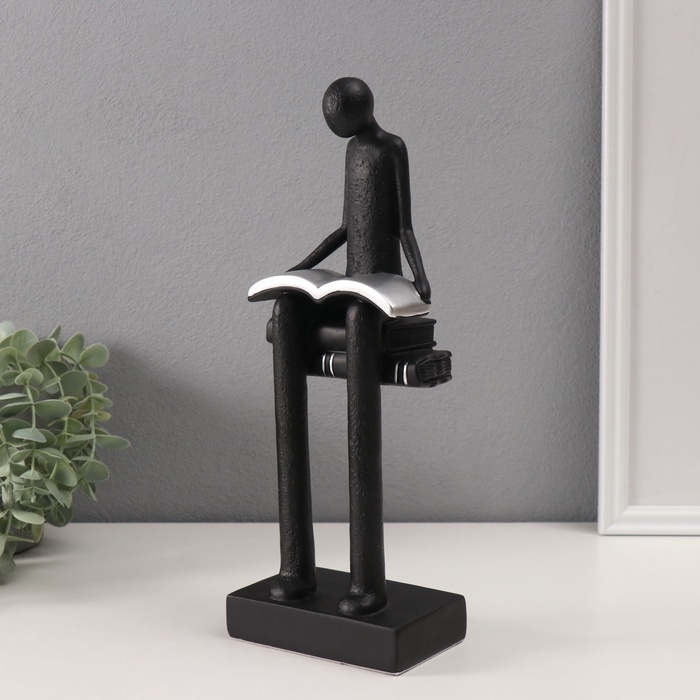 Сувенир полистоун "Абстракция. Человек сидит на книгах читает" черный с серебром 7,5х11х30см
